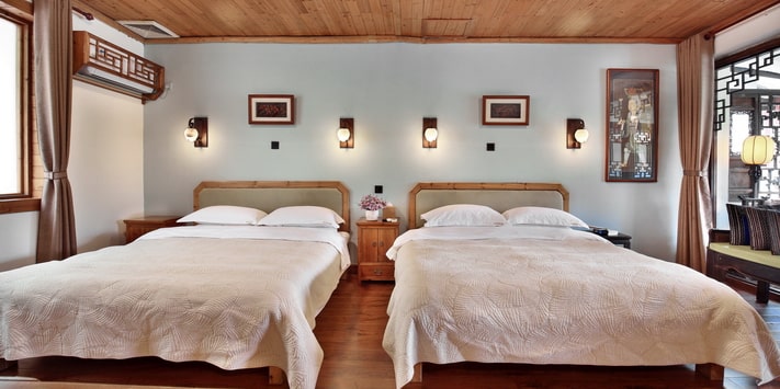 A secluded side entrance leads to the second floor of Yangshuo Mountain Retreat where a double queen bed room affords stunning views of the Yulong River. Find out why we are consistently among top Yangshuo hotels for 17 years.