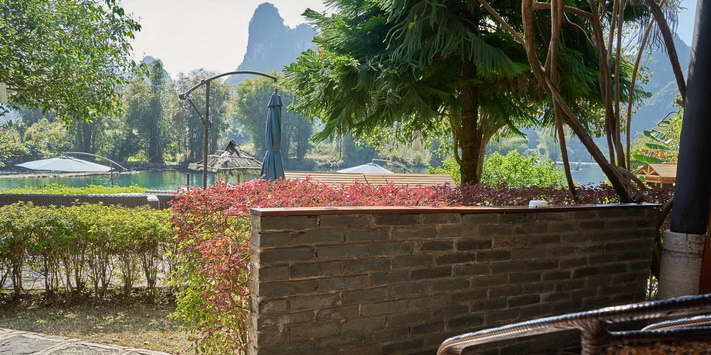 Enjoy a shaded terrace with beautiful views of the Yulong River and Yangshuo Mountain Retreat garden.